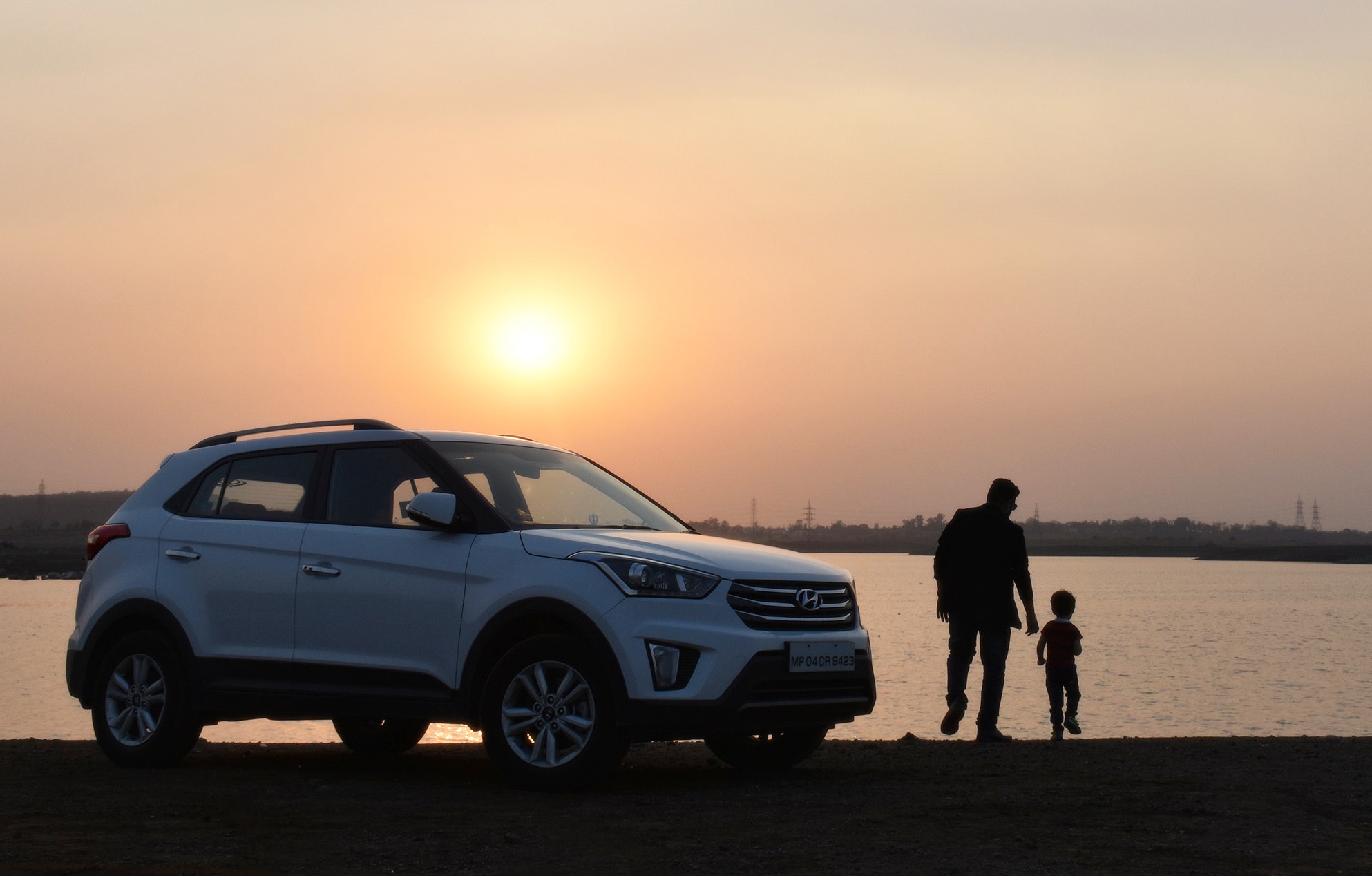 silhouette-of-man-and-child-near-white-hyundai-tucson-suv-1134857
